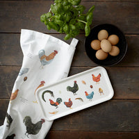 Kitchen items with chicken design on a wooden surface
